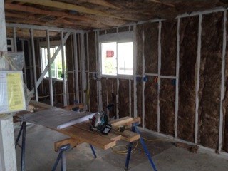 Before: A room opened to the studs with insulation in the walls.