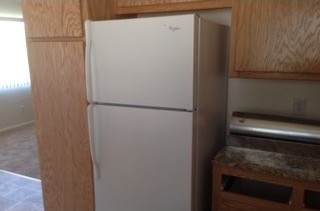 After: new cabinets and a clean refrigerator.