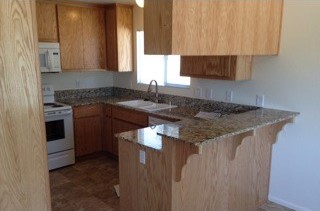 After: new oak cabinets and granite counters.