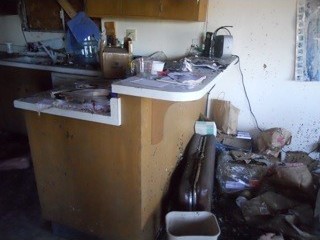 Before: A kitchen full of burned debris.