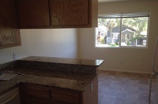 After: a clean kitchen with new cabinets.