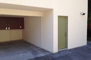 After: a finished wall with a new green door.